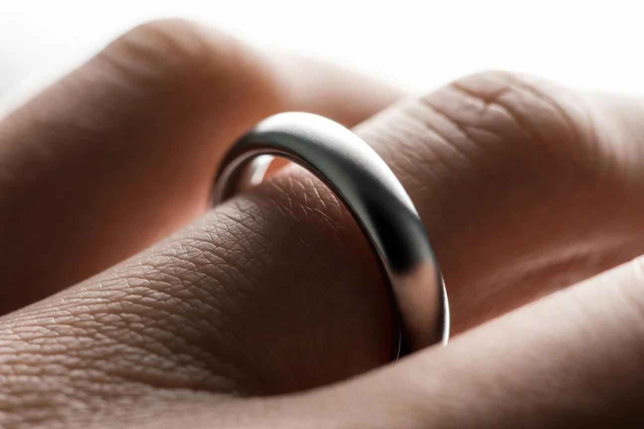 Close-up of the smaller Oura Ring 5 smart ring on a finger, highlighting its thin design and health features.